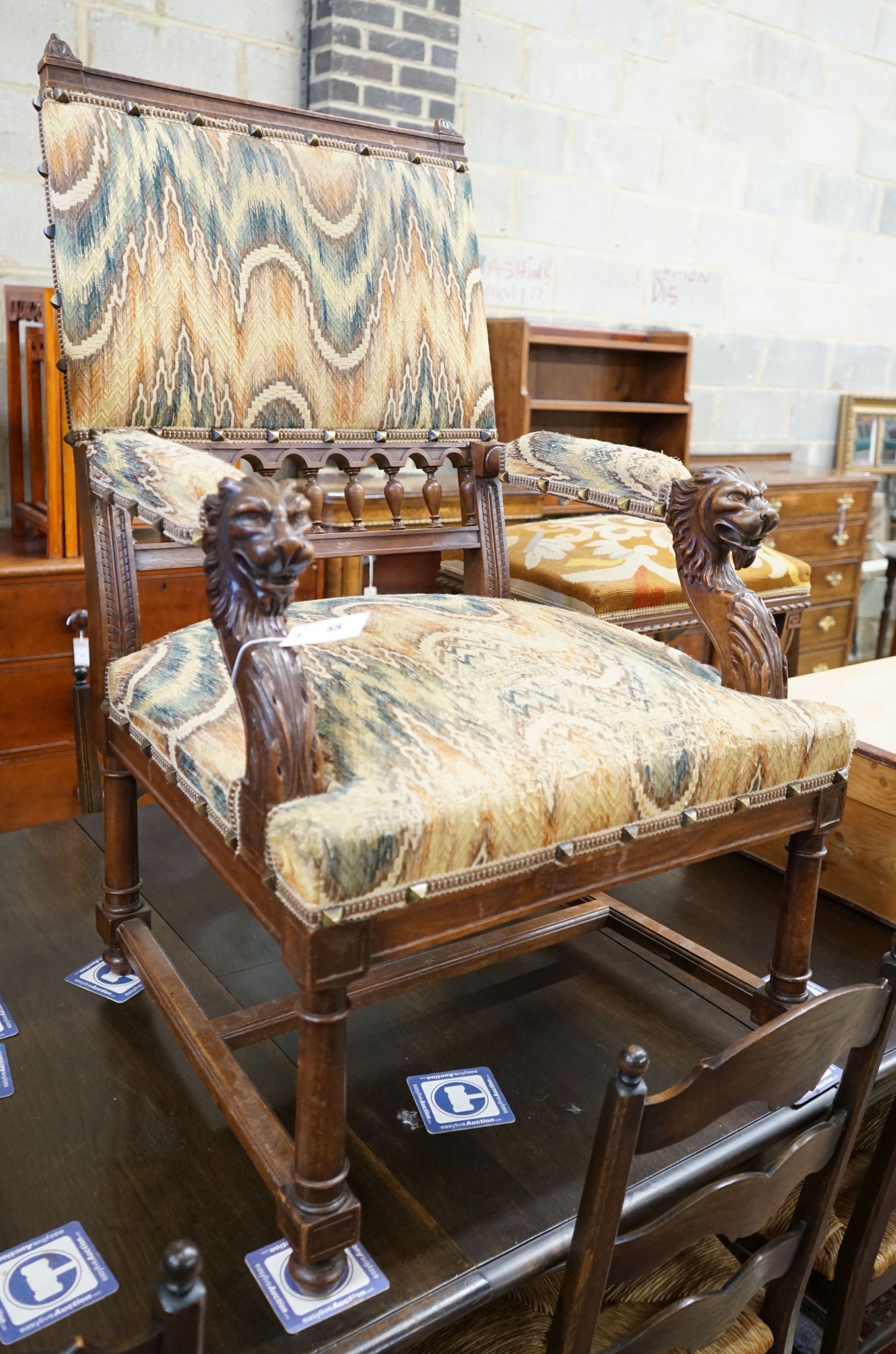 An early 20th century French walnut elbow chair with carved lion head arms, width 63cm, depth 60cm, height 106cm